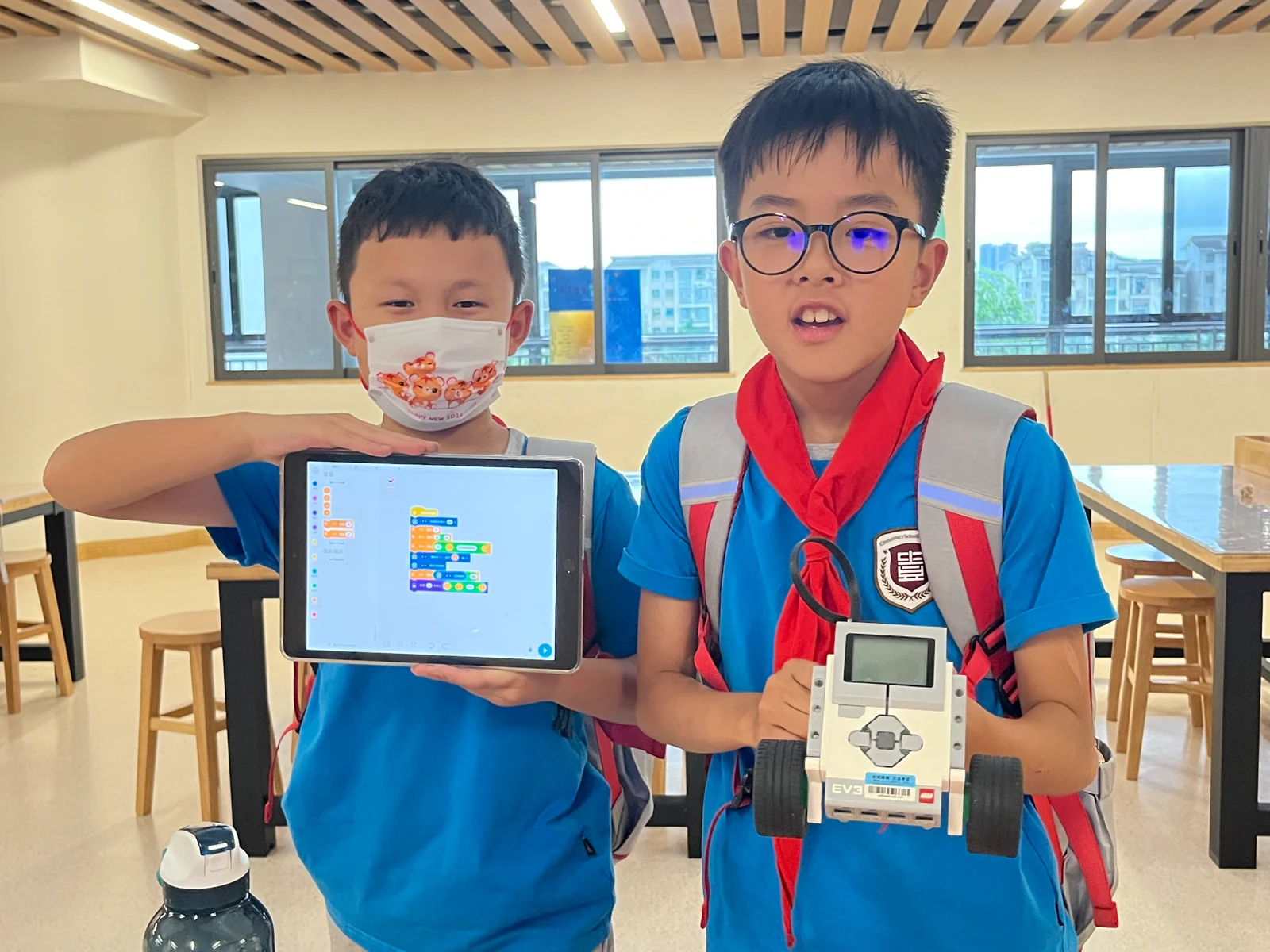 Students share tablet programming and a robot build · Historical photograph